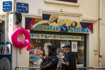 Policías ante una tienda cerrada en las cercanías del Puerto Viejo. Guillaume FAUVEAU